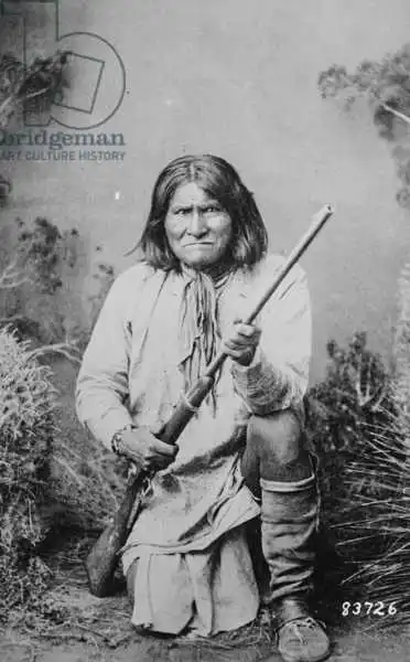 American photographer: Geronimo holding a rifle